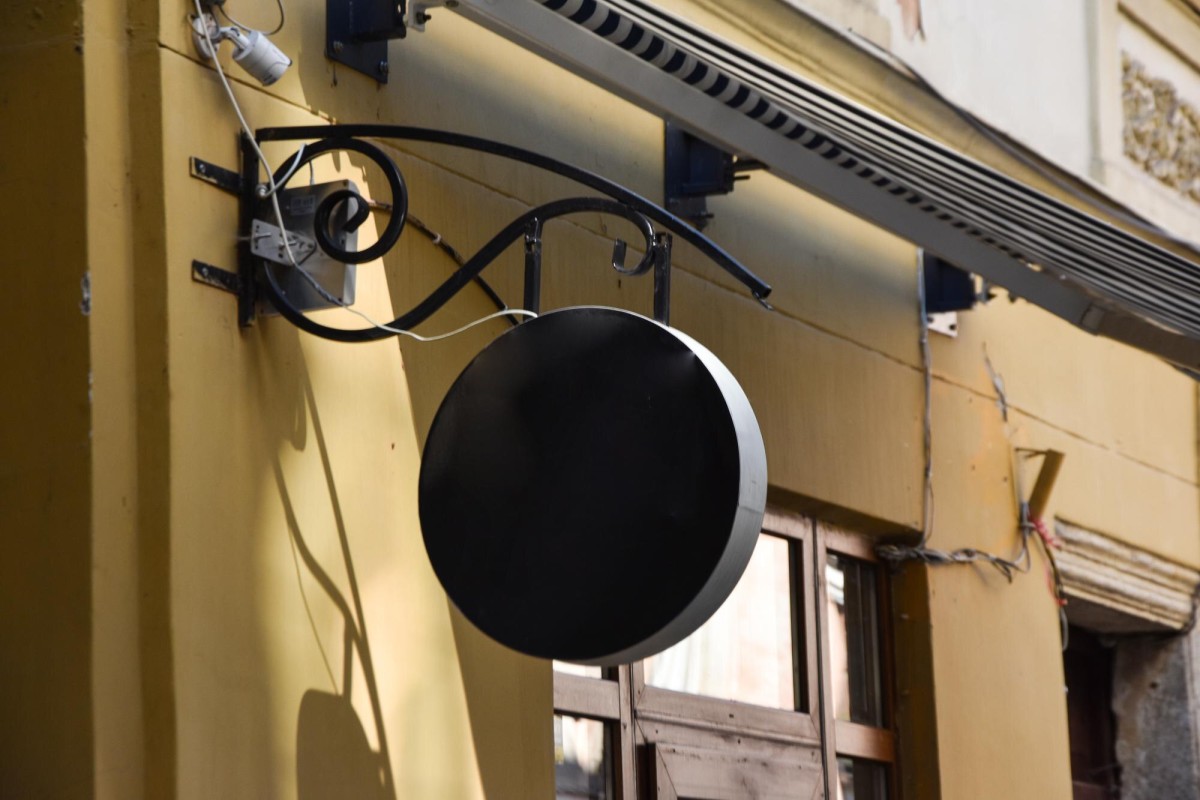 Illuminated storefront business sign on building